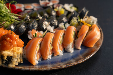 Sushi platter with assorted rolls salmon, tuna, cucumber, avocado, seaweed, rice, tempura