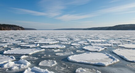 Obraz premium Frozen lake landscape representing winter's grip and serenity, with ice floes and distant shoreline