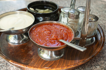 Vietnamese sauces set on the table in a street restaurant closeup. Mayonnaise, garlic dressing