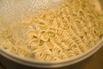 Boiling pasta noodles in a pot of hot water