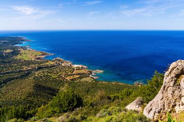Stunning aerial panoramic view of rugged and rocky coastline of Cyprus with turquoise waters and steep sea cliffs. Summer Mediterranean seascape, wild nature and natural landscape.