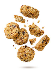 Granola cookies and pieces flying close-up on a white. Isolated