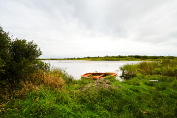 View of the pond on the Danish island of Römo near Nörre Tvismark and the surrounding landscape.
