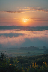 Obraz premium orange sunset glowing over mountain peak with meadow field and dramatic fog scenic photography nature landscape outdoor golden light landscape photography wallpaper background