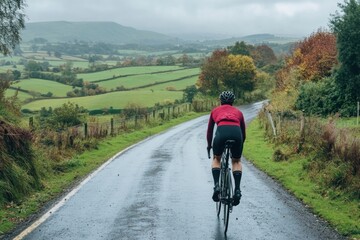 Cyclist riding on scenic country road in autumn