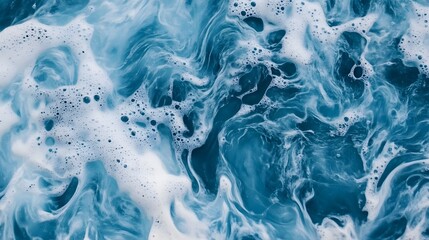 Obraz premium Photograph of swirling, textured foam in deep teal and white, creating dynamic patterns.