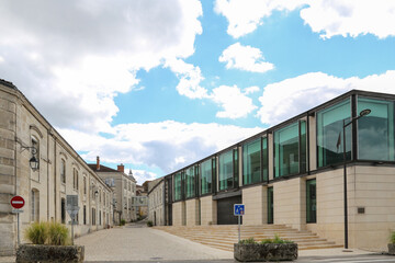 A building with a blue sign on it in Cognac France