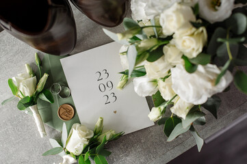 Wedding day. Bouquets and various wedding accessories, shoes, invitations, rings in the morning at the bride's preparation