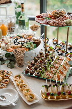 Wedding day. Buffet table with various types of snacks and sweets in the celebration hall