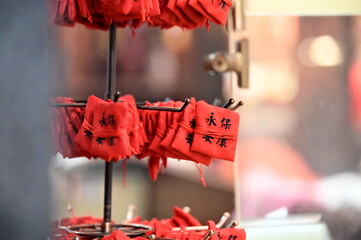 TWN-Mar 02, 2025: A red amulet marked with “Eternal Peace” sits neatly on a shelf inside a Taiwanese temple. Symbolizing protection and harmony, it reflects cultural traditions and spiritual beliefs.