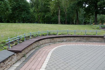 Wooden benches and chaise lounges for rest on the streets of the city and in the park, public places