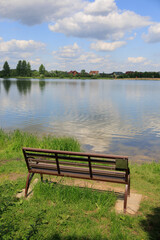 Fototapeta premium Benches for relaxing on the embankment near the lake, public places
