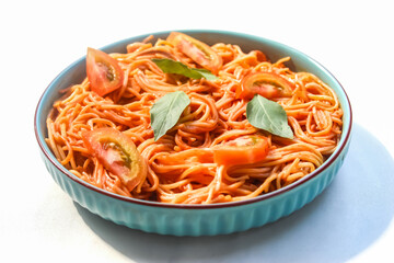 spaghetti bolognese in a plate with sliced ​​tomatoes and basil leaves isolated on white background