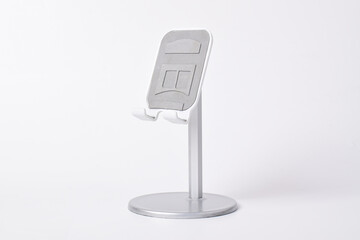 Metal alloy adjustable phone holder. Folding desktop phone stand isolated on white background.