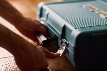 Hands skillfully opening a professional tool case designed specifically for high-quality equipment