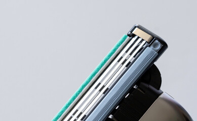 Close-Up of Triple Blade Razor Head on Light Background - Shaving Tool Macro