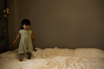 Child Is Playing On The Bed In The Bedroom