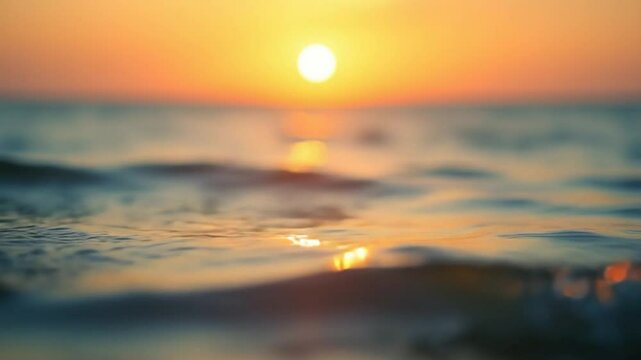 Abstract sea summer ocean sunset nature background. Small waves on golden water surface in motion blur with golden bokeh lights from sun. Holiday, vacation and recreational concept. Nobody Slow motion