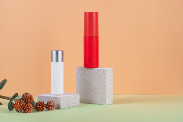 Cosmetic red bottle. Womens cosmetic accessory for makeup with stylish props on cream background.