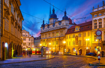 Fototapeta premium Prague, Czech Republic. Old town square with antique vintage tram public transport. Dark evening street blue hour sky.