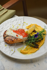 Lobster with citrus slices and spinach on white plate