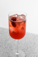 Studio red cocktail with berries and ice