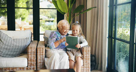 Relax, grandmother and child with tablet on sofa for playing online game, watching cartoon and weekend visit. Love, old woman and girl with digital app in home for social media and bonding together