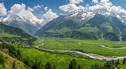 Fototapeta premium Panoramic view of lush green valley surrounded by majestic mountains under clear skies