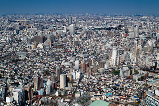 High-angle panoramic view of dense urban skyline across northern Ikebukuro and Itabashi City with residential and commercial buildings under clear winter sky (Tokyo, Japan &ndash; January 2025)