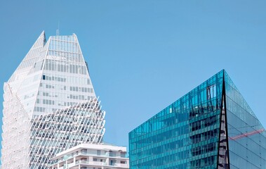 A wide-angle daytime view of the Casa Finance City district in Casablanca, Morocco, showcasing a cluster of contemporary high-rise buildings with unique architectural designs under a clear blue sky