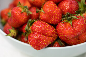 Close-up of Fresh, Ripe Strawberries in a White Bowl