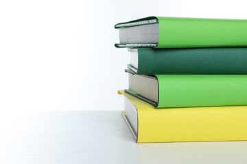 Stack of colorful books on white background