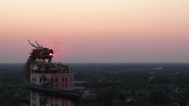 Aerial of dragon Wat Sam Phran temple at sunset