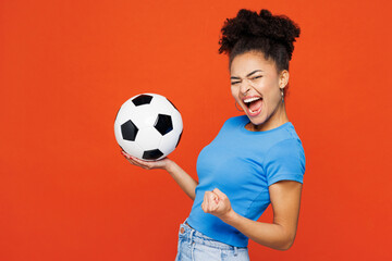 Young woman fan wears blue t-shirt cheer up support football sport team hold in hand soccer ball...