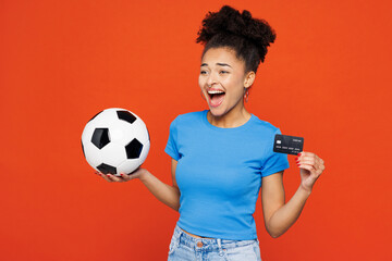 Young happy woman fan wearing blue t-shirt cheer up support football sport team hold soccer ball...