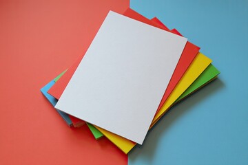 Colorful papers stacked on a vibrant background