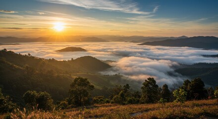 Obraz premium Serene sunrise over misty mountains with lush greenery and soft clouds