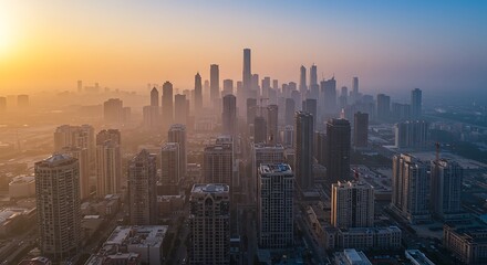 Fototapeta premium Misty Cityscape at Dawn: Skyscrapers Emerge from Golden Haze