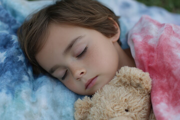 Child peacefully asleep with stuffed animal outdoors