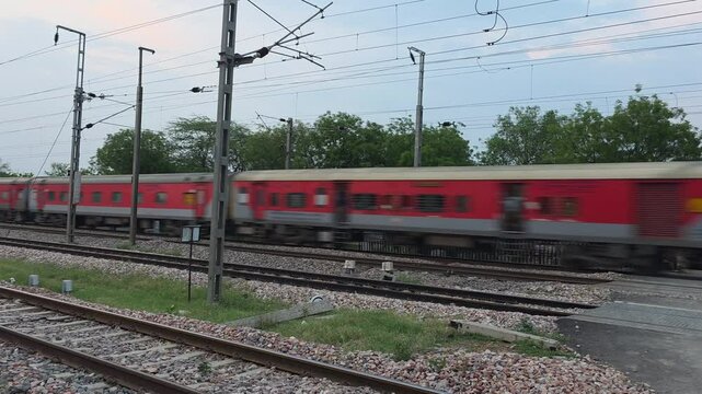 Train passing intersection of tracks and road