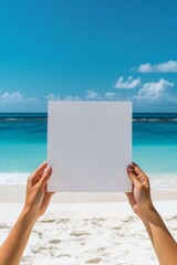 Hands Holding Blank Card on Tropical Beach with Ocean Background