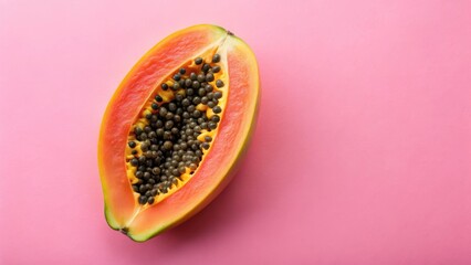 Fresh papaya fruit with a slight ripeness on a soft pink background