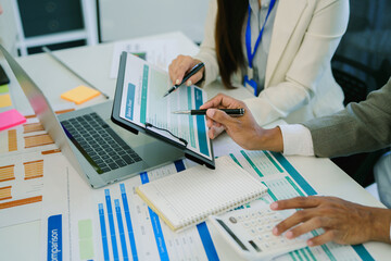 Coworkers team at work. Group of young business people in trendy casual wear working together in creative office.
