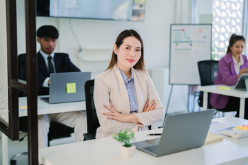 Asian businesswoman standing and sitting in office