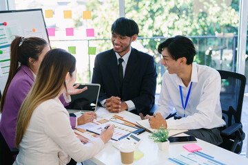 Business team woman and man asian group meeting sitting on desk looking talk think creative idea computer on table ready happy working new project job online product sale marketing in office company.