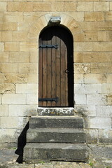 Oak front door and stone steps of an old building