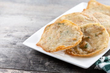 Tortillitas de camarones on wooden table. Traditional spanish food.