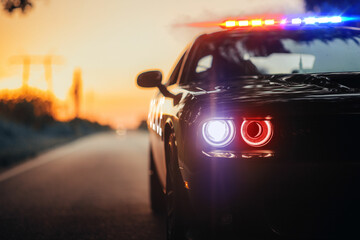 Police car. Police car chasing a car. 911 Emergency response police car speeding to scene of crime. Selective focus on car © Asad