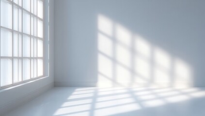 Sunlight streams through large windows into a bright, empty white room, casting geometric shadows on the floor.