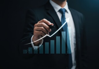 A businessman draws an upward trending arrow on a bar graph representing financial growth